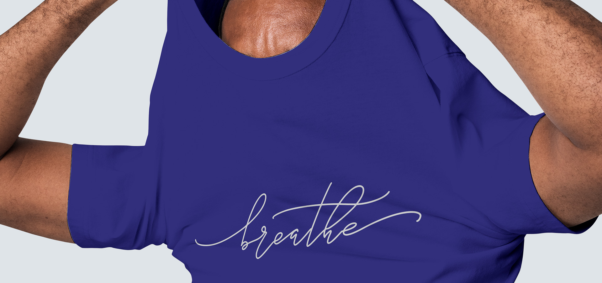 A Person taking off a Blue Breathe T-shirt